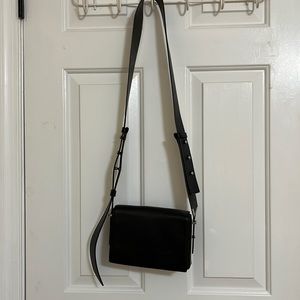 Leather 3 compartment shoulder bag. Adjustable wide strap. Silver hardware.